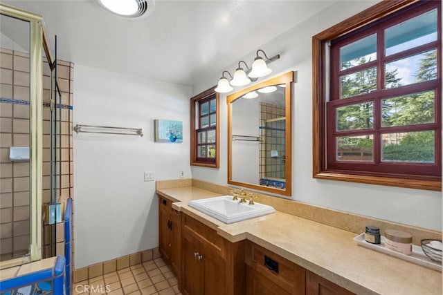 full bathroom with plenty of natural light, vanity, baseboards, and tile patterned floors