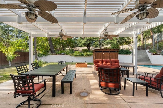 view of patio featuring a fenced backyard, stairway, outdoor dining area, and a pergola