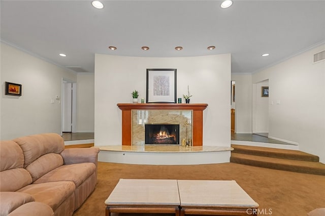 living room with recessed lighting, a fireplace, crown molding, and visible vents