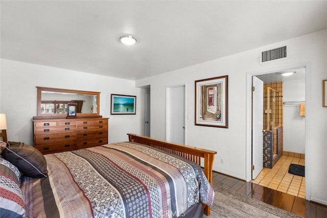 bedroom with visible vents and wood finished floors