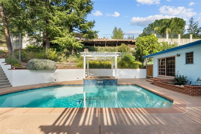 view of pool featuring a patio, fence, a pool with connected hot tub, and a pergola