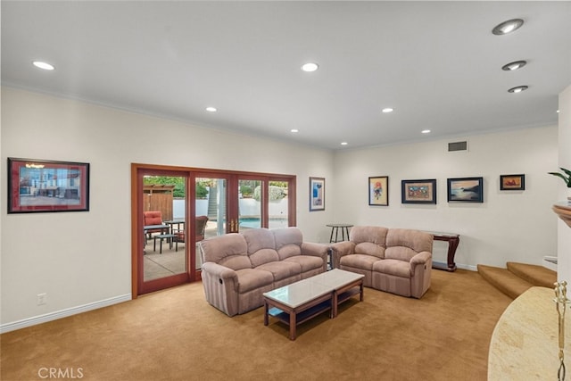 living room with light colored carpet, visible vents, and crown molding