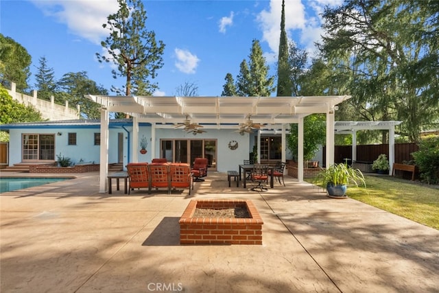 back of property with ceiling fan, a patio, fence, a pergola, and an outdoor living space with a fire pit