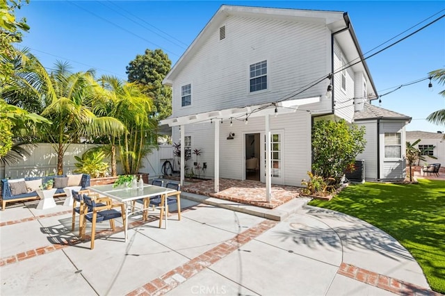 rear view of house with a yard, a fenced backyard, central AC, and a patio