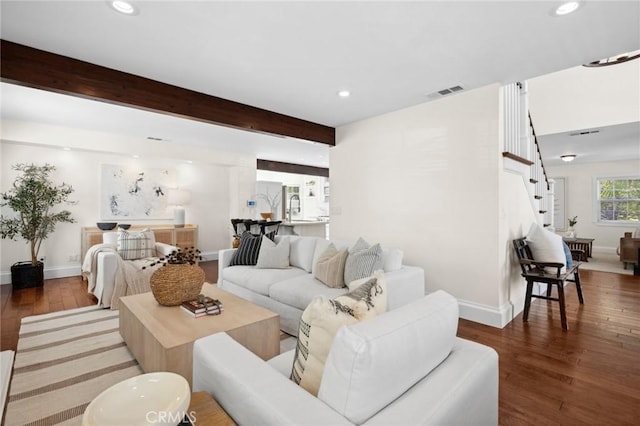 living room with visible vents, dark wood finished floors, beamed ceiling, stairs, and recessed lighting