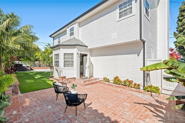 rear view of property with a yard and a patio