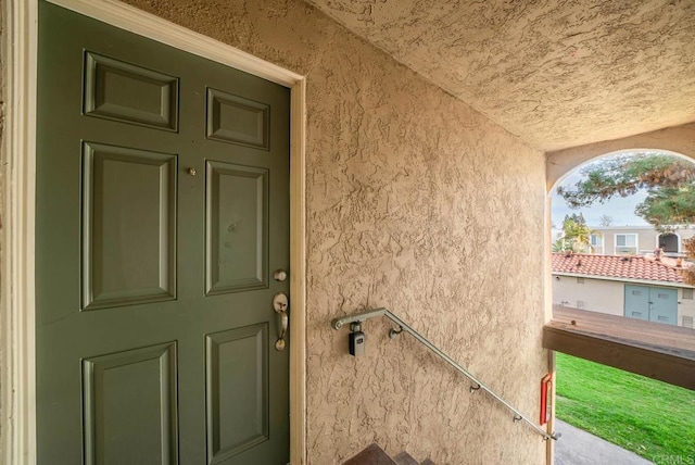 view of exterior entry with stucco siding