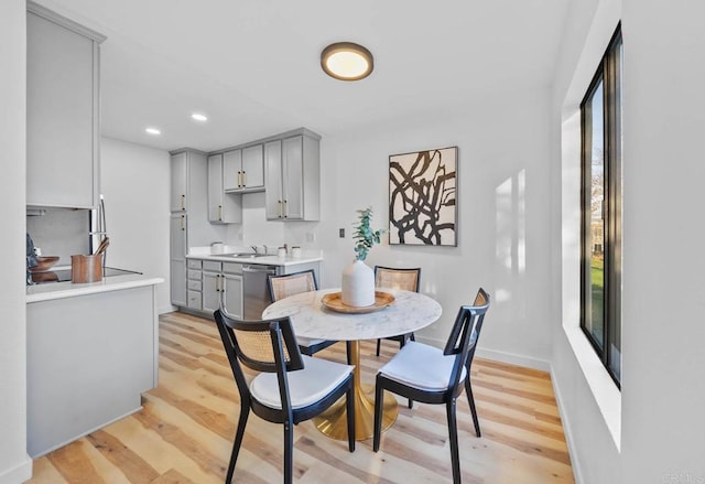 dining room with baseboards, recessed lighting, and light wood-style floors