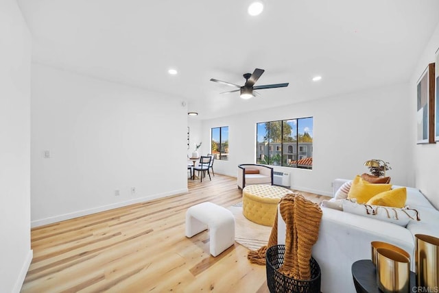 living area featuring baseboards, ceiling fan, recessed lighting, and light wood-style floors