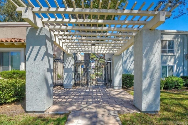 view of patio featuring a gate, fence, and a pergola