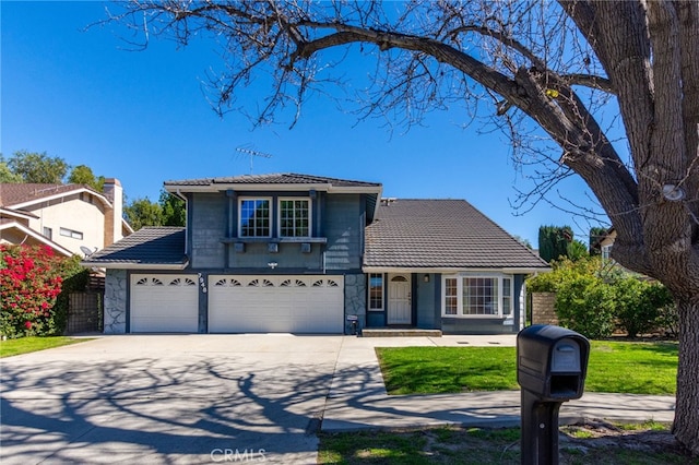 view of front of house featuring driveway, stone siding, and a tile roof