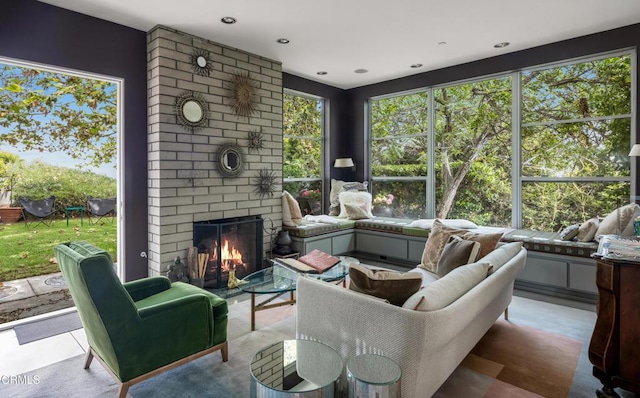 sunroom / solarium with a brick fireplace