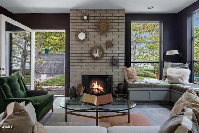 living room with a brick fireplace