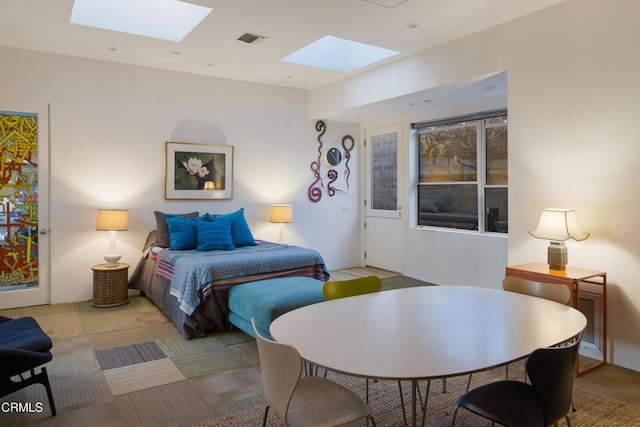 bedroom with a skylight and visible vents