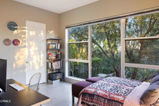 bedroom featuring finished concrete floors