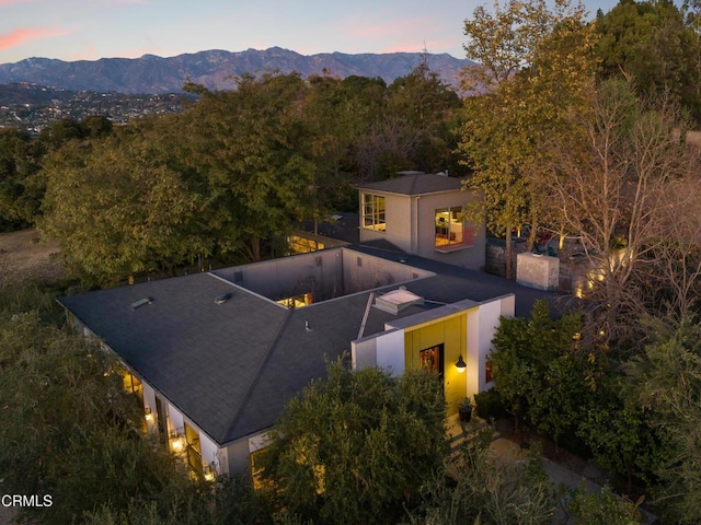 aerial view at dusk featuring a mountain view