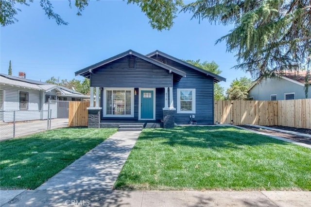 view of front of home with fence and a front yard