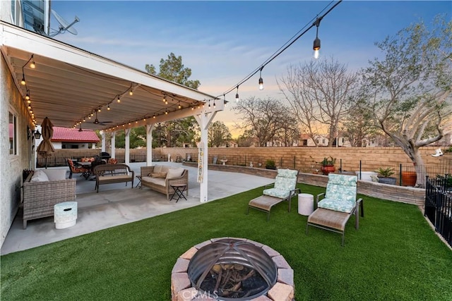 view of yard with a fenced backyard, a patio, and an outdoor living space with a fire pit