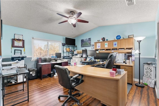 office area with visible vents, light wood-style flooring, vaulted ceiling, a textured ceiling, and ceiling fan