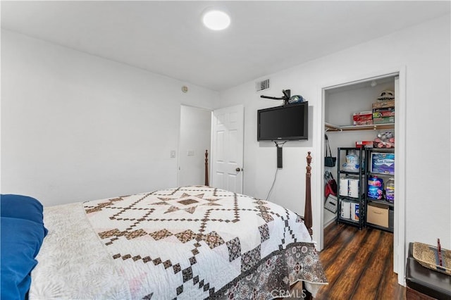 bedroom with visible vents and dark wood finished floors