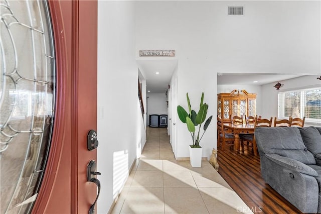 tiled entryway with baseboards, visible vents, and recessed lighting