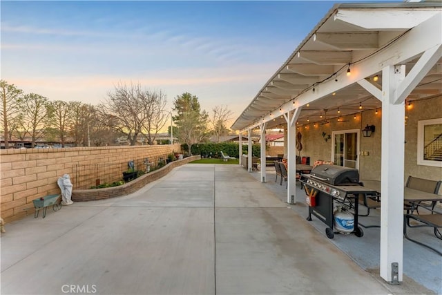 view of patio with area for grilling and a fenced backyard