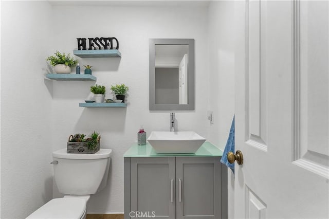 bathroom with toilet and vanity