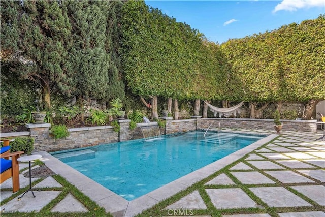 outdoor pool featuring a patio