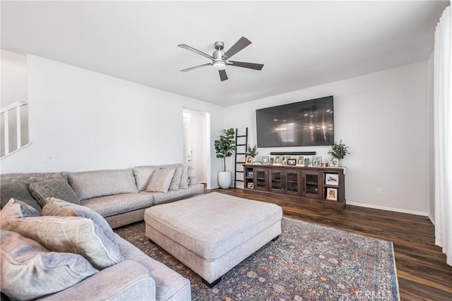 living room with dark wood-type flooring, stairs, baseboards, and a ceiling fan