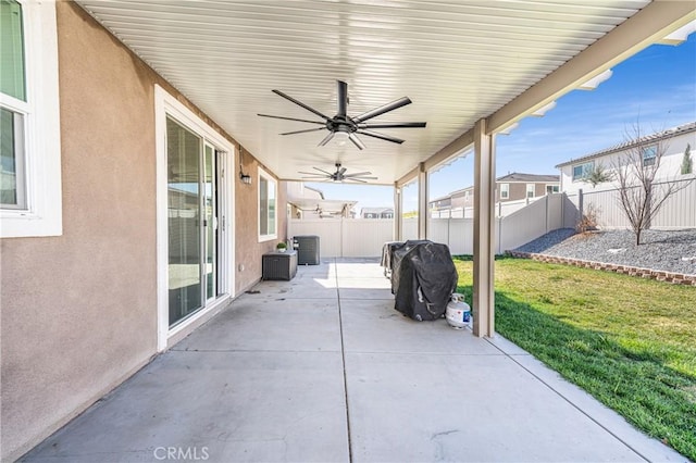 view of patio with a fenced backyard, ceiling fan, area for grilling, and central air condition unit