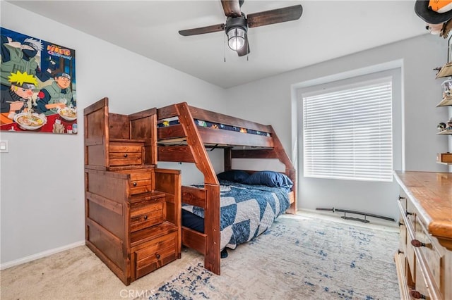 bedroom with a ceiling fan, light carpet, and baseboards