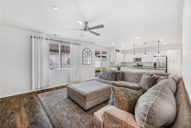 living room with dark wood finished floors, recessed lighting, visible vents, a ceiling fan, and baseboards