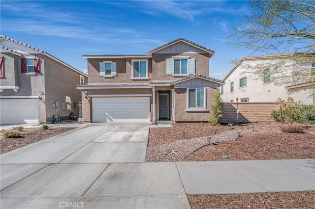 traditional home with concrete driveway, an attached garage, fence, board and batten siding, and stucco siding