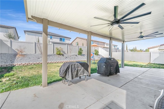 view of patio featuring area for grilling, a fenced backyard, and a ceiling fan