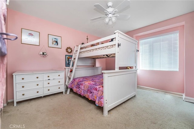 bedroom featuring light carpet, ceiling fan, and baseboards