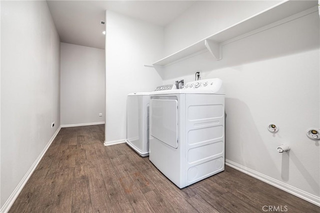 laundry room with baseboards, laundry area, washer and clothes dryer, and dark wood-style flooring