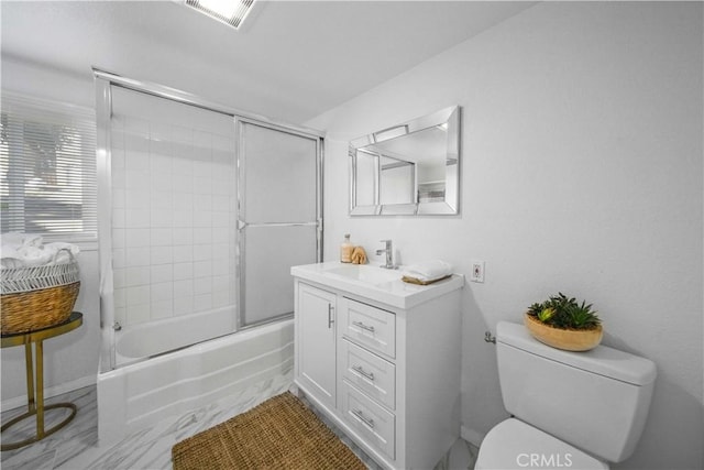 bathroom with enclosed tub / shower combo, toilet, vanity, and visible vents