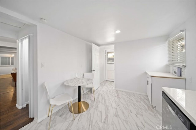 dining area featuring recessed lighting, marble finish floor, and baseboards