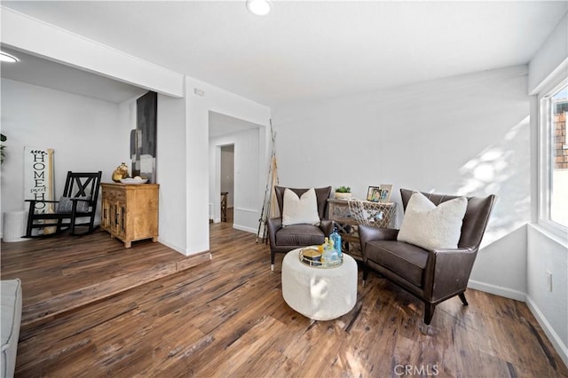 sitting room with dark wood-style flooring, a wealth of natural light, and baseboards