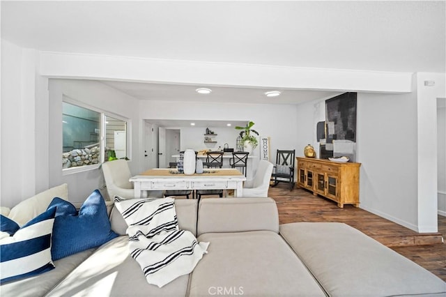 living area featuring baseboards and wood finished floors