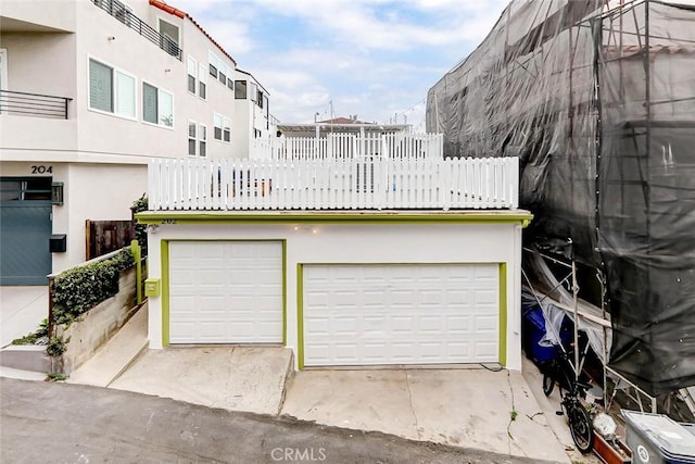 exterior space with a garage and stucco siding