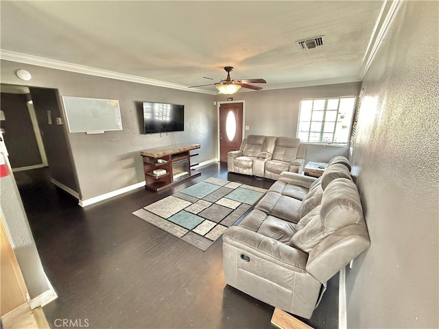 living area featuring visible vents, baseboards, a ceiling fan, dark wood finished floors, and crown molding