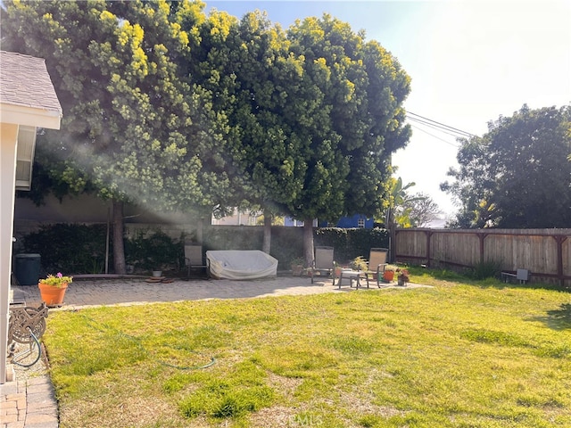 view of yard featuring fence and a patio