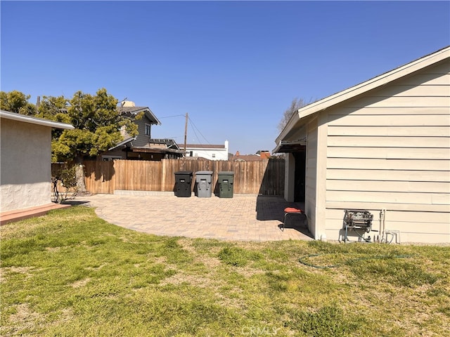 view of yard featuring fence and a patio