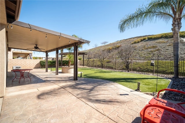 view of patio / terrace with a fenced backyard and a ceiling fan