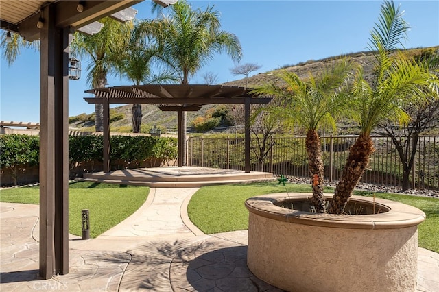 view of property's community featuring fence, a patio, and a pergola