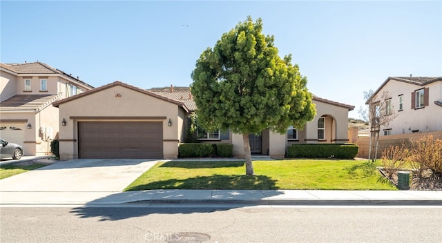 mediterranean / spanish-style house with driveway, a garage, stucco siding, a tile roof, and a front yard