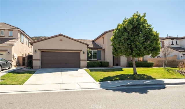 view of front of house featuring an attached garage, concrete driveway, a tiled roof, stucco siding, and a front lawn