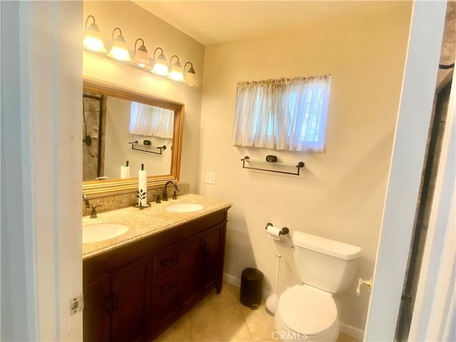 full bath featuring toilet, tile patterned flooring, double vanity, and a sink