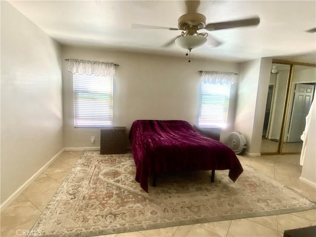 bedroom featuring light tile patterned flooring, a ceiling fan, and baseboards